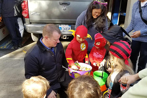 Handing out Halloween candy to the local preschoolers, outside of Paul's Automotive.